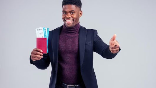 cafrican-business-traveller-with-ticket-boarding-pass-passport-white-background-studioautumn-winter-trip_175356-6688