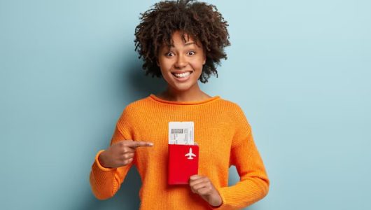 photo-glad-dark-skinned-curly-female-traveller-points-tickets-passport-rejoices-having-trip-abroad-summer-holidays_273609-25451